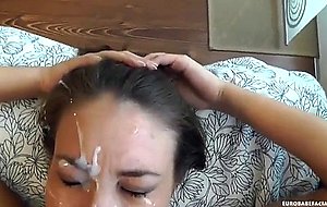 Shocked teen cant believe the amount of cum on her face