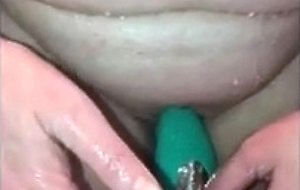 Wife masturbating with a toy in the shower
