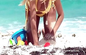 Latin shemale in yellow bikini at beach masturbating in the ocean