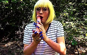 Blonde trans girl deepthroats vibrator outside