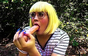 Blonde trans girl deepthroats vibrator outside