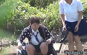 Asian teens pissing outdoors  
