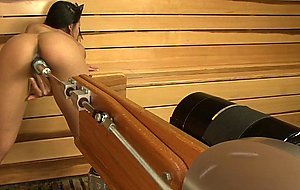 Squirting hottie fucks machine in sauna