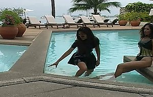 Two black ladies in latex swimwear tease on the pool and by the beach