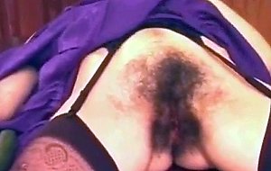 Hairy mature lady fucks a cucumber and has a squirting orgasm