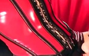 Tranny in latex corset drilled from behind