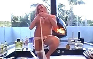  blonde  stripping  in  fishnet  stockings  and  garter  belt