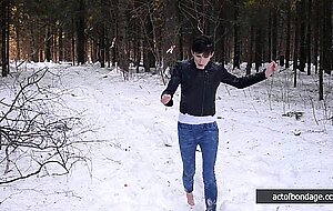 Barefoot Claudia is captured in the cold winter forest