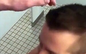 Handsome guy sucks dick in restroom stall