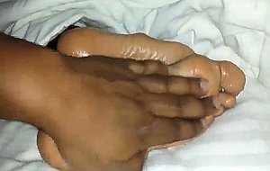 Oiled wifes foot filmed up close