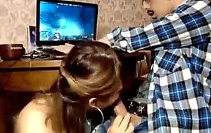 Girlfriend sucks bf's cock while he's playing computer